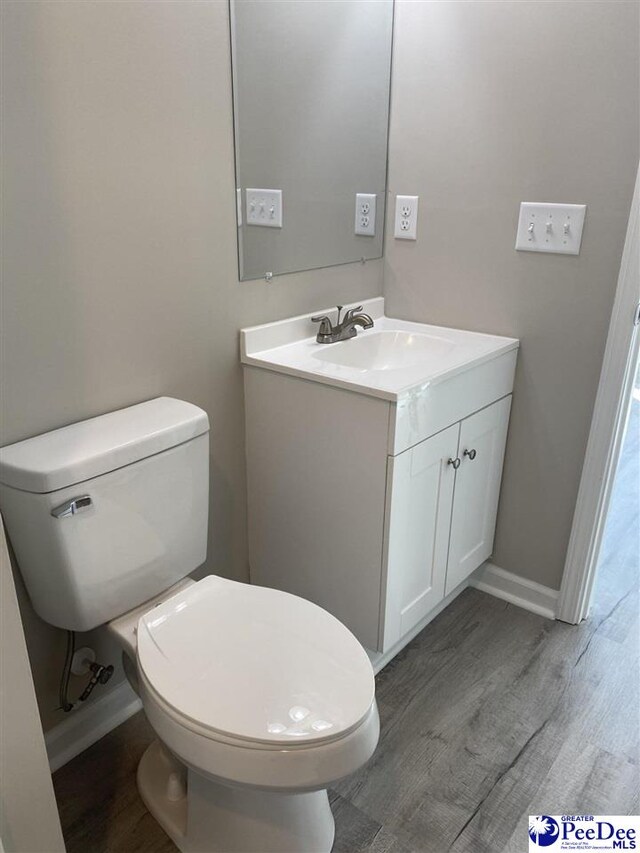 1001/1003 Jessamine Trl, Sumter, SC 29150 - half bath featuring wood finished floors, toilet, vanity, and baseboards