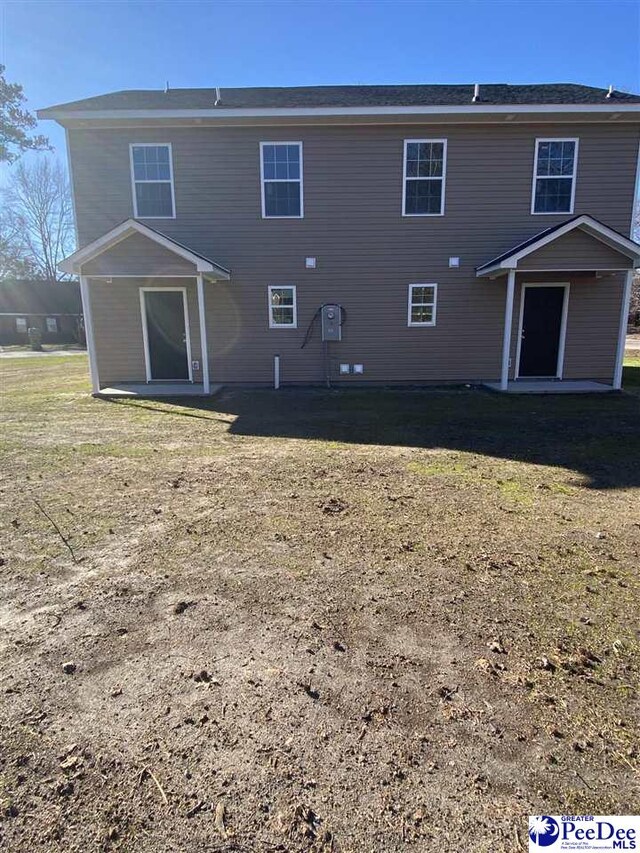 1001/1003 Jessamine Trl, Sumter, SC 29150 - rear view of house featuring a patio area and a lawn