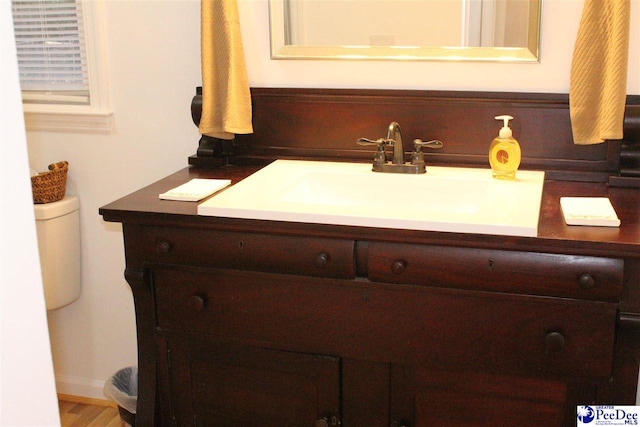 bathroom featuring vanity and toilet