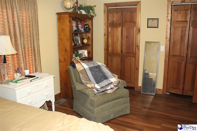 bedroom with dark hardwood / wood-style floors