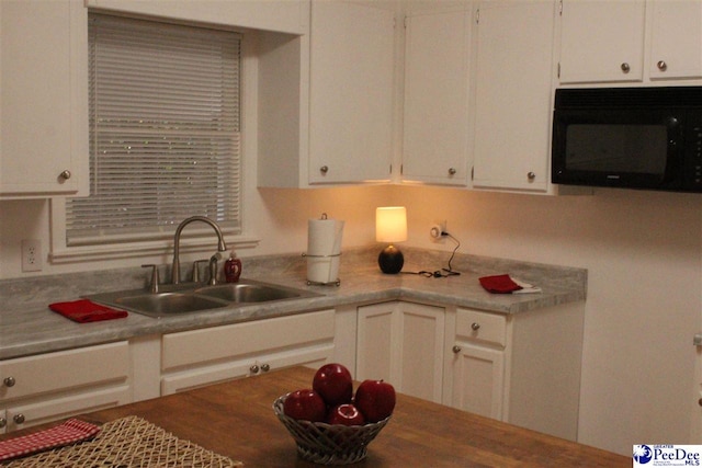 kitchen with white cabinetry and sink