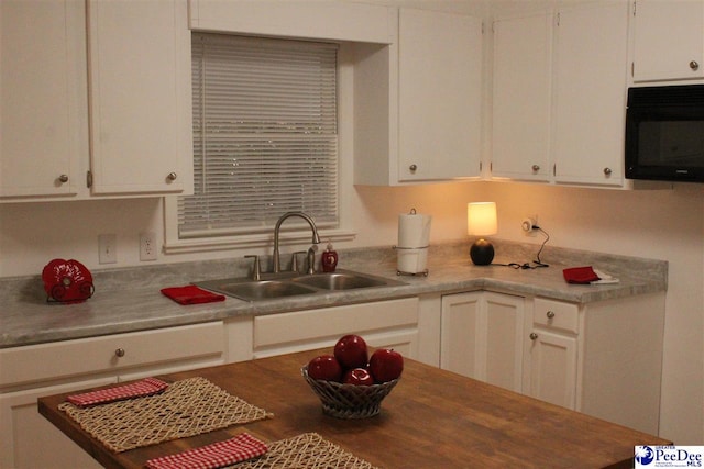 kitchen featuring sink and white cabinets