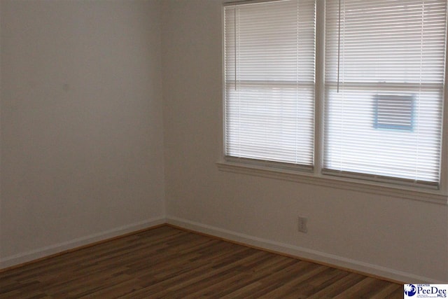 spare room featuring dark wood-type flooring