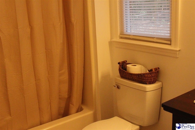 full bathroom with vanity, shower / bath combo, and toilet