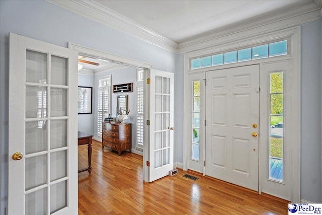 2543 Ben Hogan Cir, Florence, SC 29506 - entrance foyer featuring french doors, light wood-style flooring, crown molding, and visible vents
