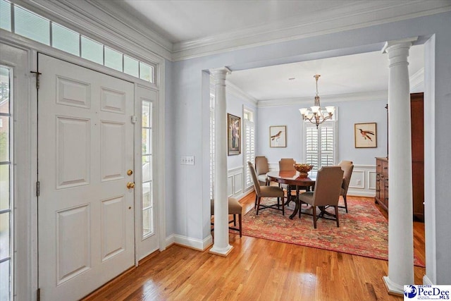 2543 Ben Hogan Cir, Florence, SC 29506 - entrance foyer with decorative columns, a decorative wall, crown molding, and light wood-style floors