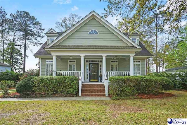 2543 Ben Hogan Cir, Florence, SC 29506 - neoclassical home with a front yard, a porch, and roof with shingles