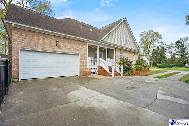 2543 Ben Hogan Cir, Florence, SC 29506 - view of front of house featuring concrete driveway, brick siding, a porch, a garage, and a shingled roof