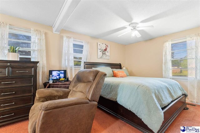 3518 Leigh Ln, Florence, SC 29505 - bedroom featuring light carpet, multiple windows, beam ceiling, and ceiling fan