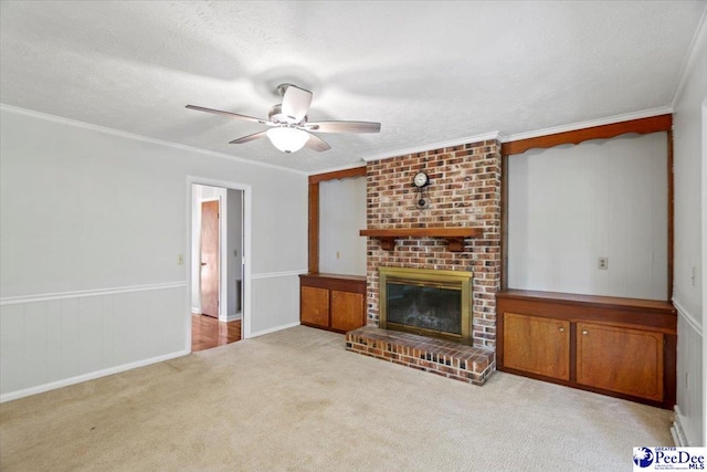 unfurnished living room with a brick fireplace, ornamental molding, light colored carpet, and a textured ceiling