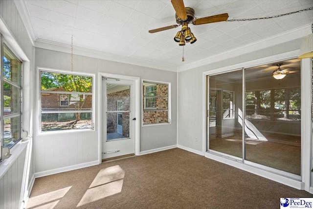 unfurnished sunroom featuring ceiling fan