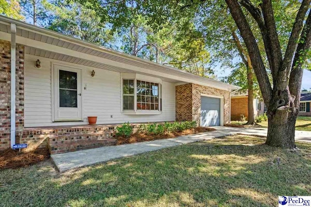 ranch-style home featuring a garage and a front lawn