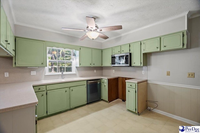 kitchen with appliances with stainless steel finishes, sink, a textured ceiling, and green cabinetry