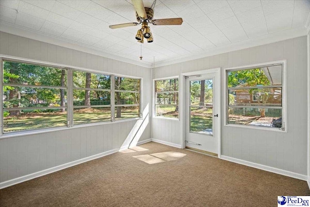 unfurnished sunroom featuring ceiling fan