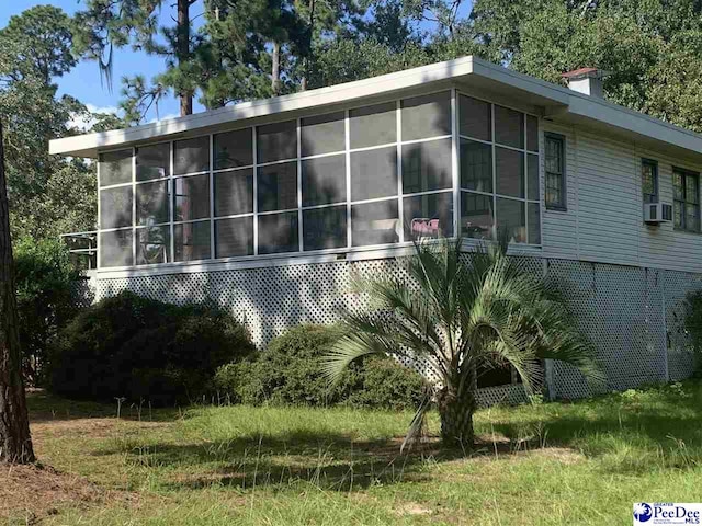 view of property exterior featuring cooling unit and a sunroom