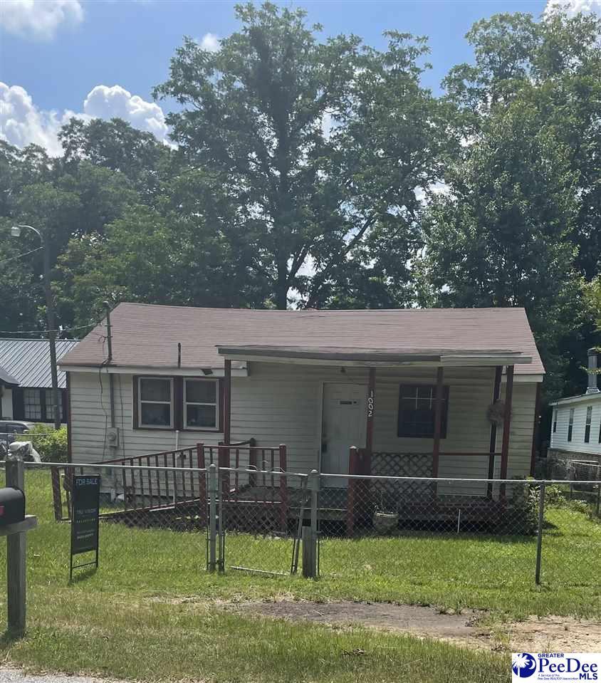 1002 N Brand St, Florence, SC 29506 - view of front of home with a fenced front yard and covered porch