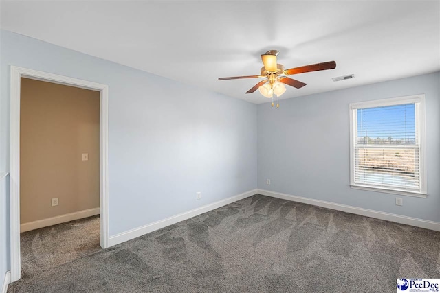 carpeted spare room with ceiling fan