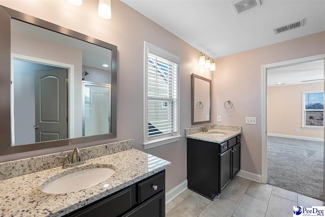 bathroom with vanity and a shower with shower door