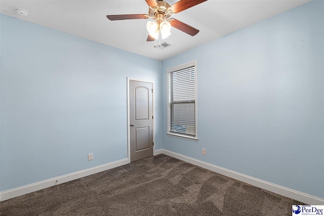 carpeted empty room featuring ceiling fan
