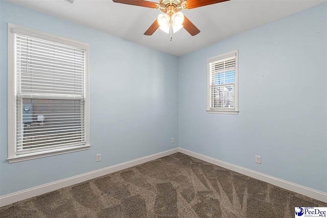 spare room featuring ceiling fan and carpet flooring