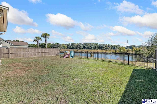 view of yard featuring a playground and a water view