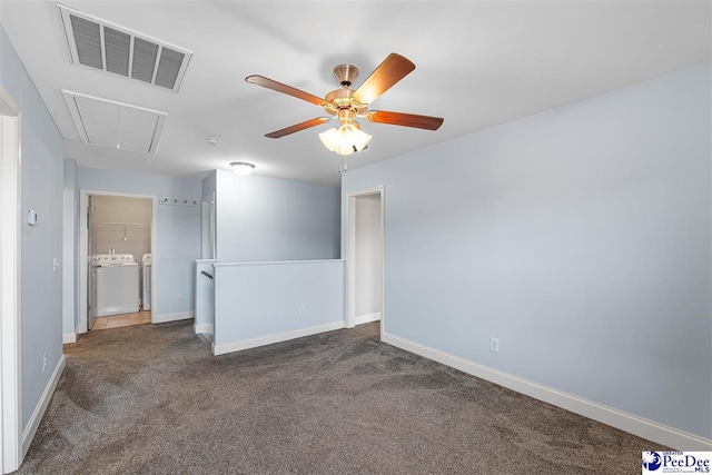 carpeted spare room with ceiling fan and washing machine and clothes dryer