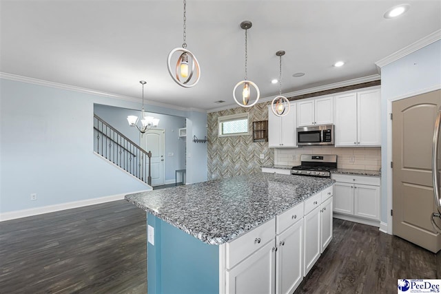 kitchen featuring appliances with stainless steel finishes, hanging light fixtures, white cabinets, a kitchen island, and dark hardwood / wood-style flooring