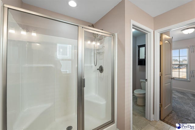 bathroom with toilet, tile patterned floors, and walk in shower