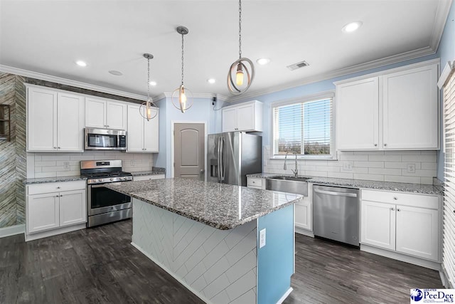 kitchen with white cabinetry, sink, pendant lighting, and appliances with stainless steel finishes
