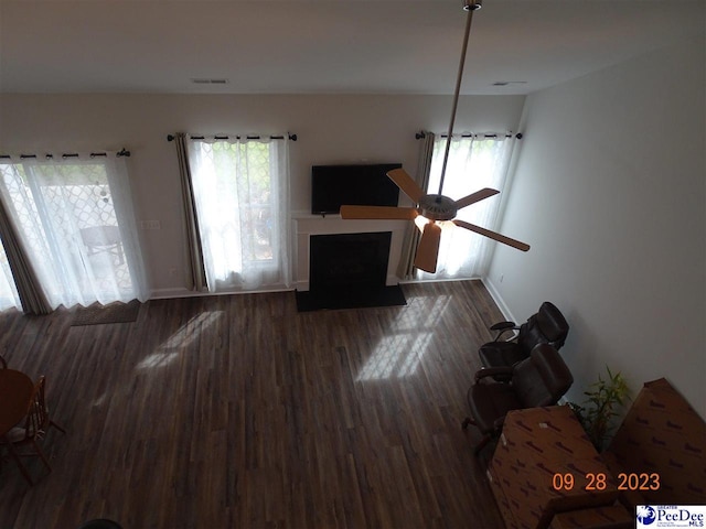 1671 Lake Wateree Dr, Florence, SC 29501 - living area with baseboards, wood finished floors, and a fireplace with flush hearth