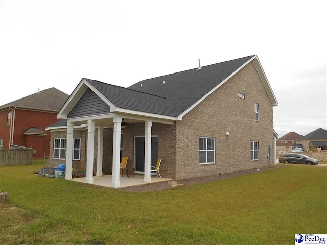 1671 Lake Wateree Dr, Florence, SC 29501 - rear view of house with a patio area, brick siding, a yard, and a ceiling fan