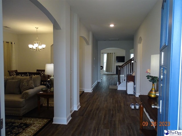 1671 Lake Wateree Dr, Florence, SC 29501 - hallway featuring arched walkways, wood finished floors, baseboards, a chandelier, and recessed lighting