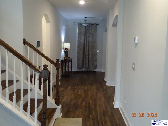 1671 Lake Wateree Dr, Florence, SC 29501 - corridor featuring arched walkways, wood finished floors, baseboards, and stairs