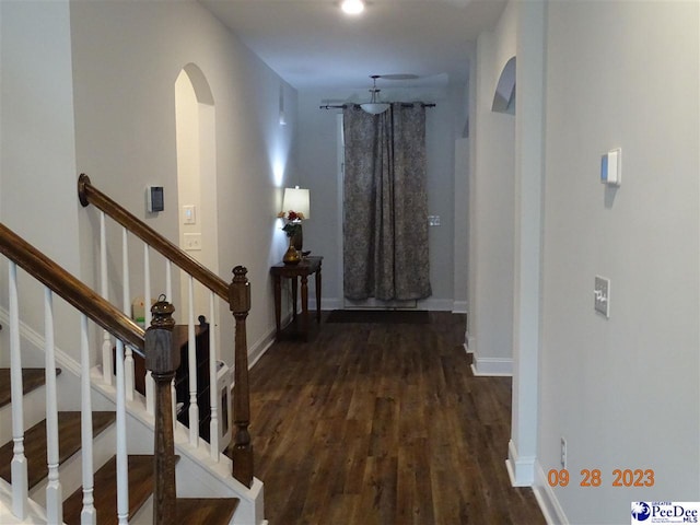 1671 Lake Wateree Dr, Florence, SC 29501 - corridor with arched walkways, wood finished floors, baseboards, and stairway