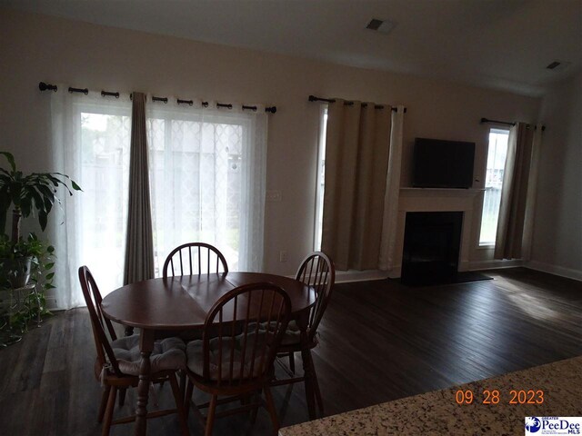 1671 Lake Wateree Dr, Florence, SC 29501 - dining space featuring dark wood-style floors, a fireplace, and baseboards