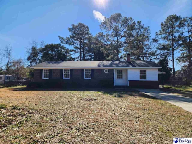 ranch-style home with a front lawn