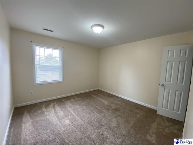 empty room with dark carpet