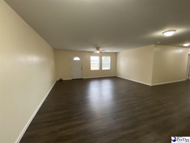 unfurnished room featuring dark hardwood / wood-style flooring and ceiling fan