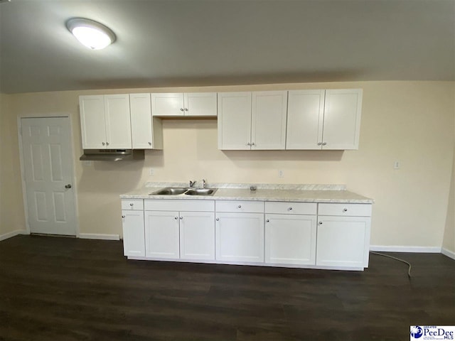 kitchen with dark hardwood / wood-style flooring, sink, and white cabinets