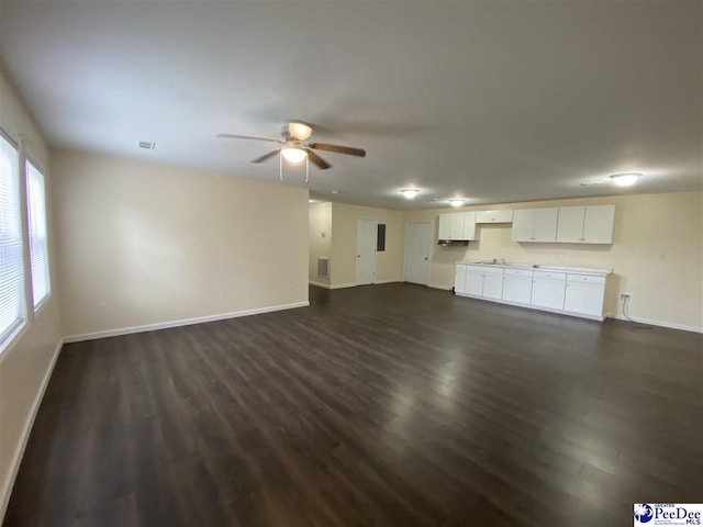 unfurnished living room with dark wood-type flooring and ceiling fan