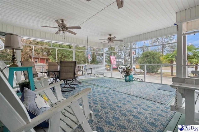 sunroom featuring ceiling fan