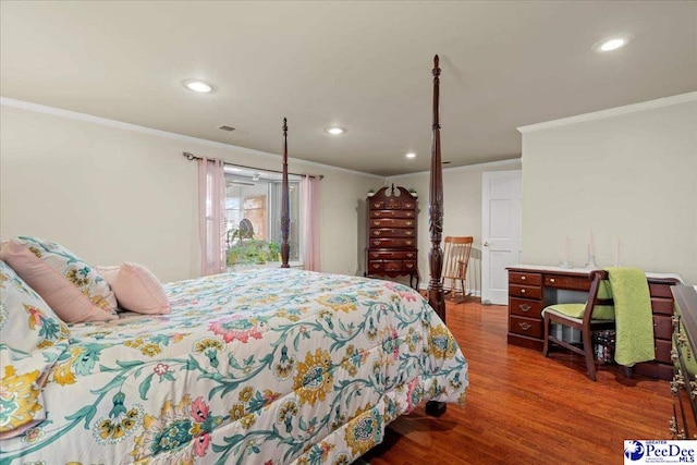 bedroom with crown molding and dark hardwood / wood-style flooring