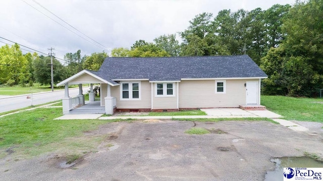 single story home with a front lawn and a porch