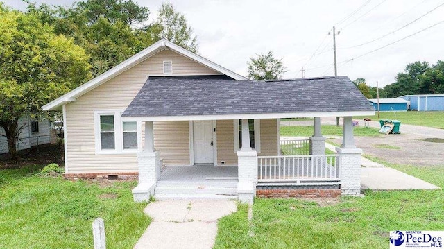 view of front of house with a porch and a front lawn