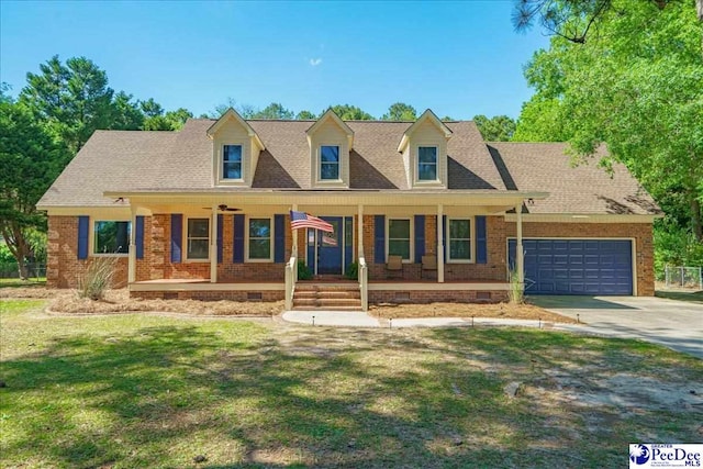 new england style home featuring a porch, a garage, and a front lawn