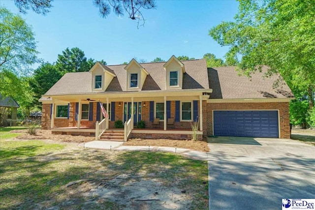 3309 W Forest Lake Dr, Florence, SC 29501 - cape cod house featuring a garage, covered porch, and a front lawn