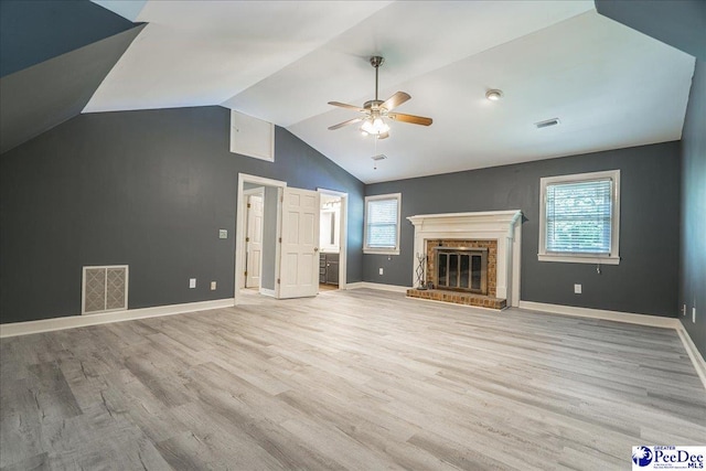 3309 W Forest Lake Dr, Florence, SC 29501 - unfurnished living room with ceiling fan, lofted ceiling, a brick fireplace, and light wood-type flooring