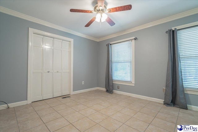 3309 W Forest Lake Dr, Florence, SC 29501 - unfurnished bedroom with light tile patterned flooring, ceiling fan, ornamental molding, and a closet