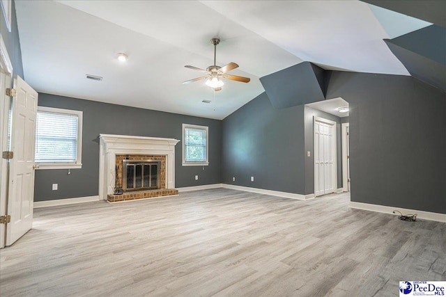3309 W Forest Lake Dr, Florence, SC 29501 - unfurnished living room featuring a brick fireplace, vaulted ceiling, light hardwood / wood-style floors, and ceiling fan