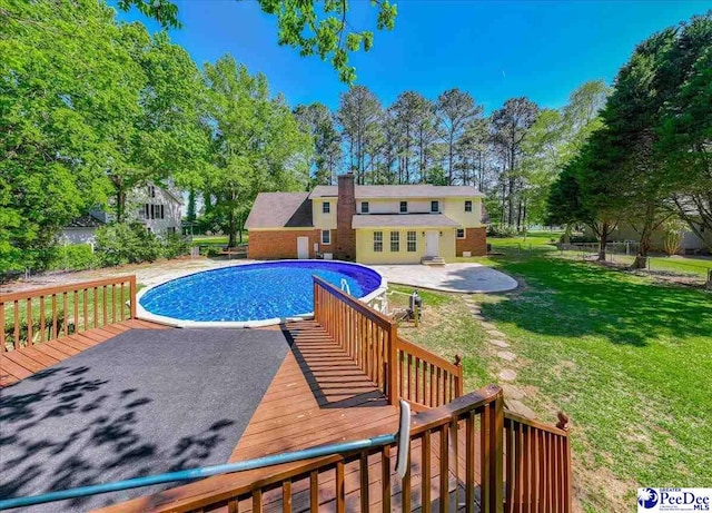 3309 W Forest Lake Dr, Florence, SC 29501 - view of swimming pool featuring a wooden deck, a yard, and a patio area